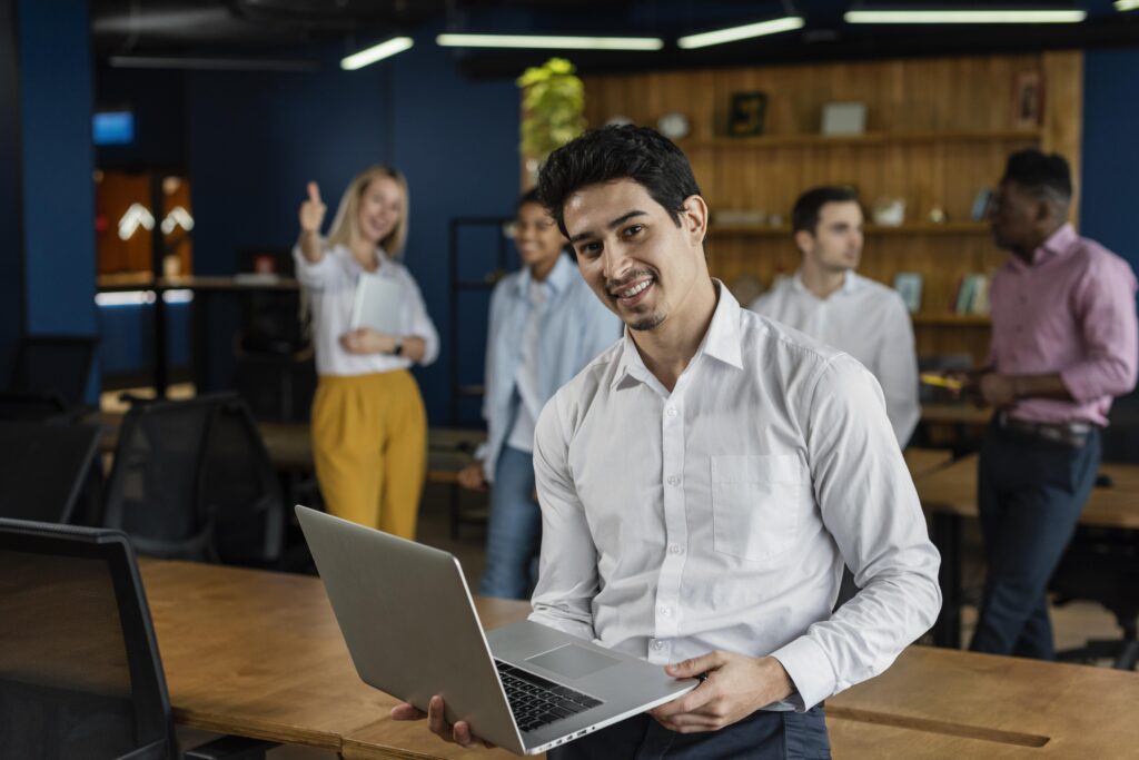 smiley-man-work-holding-laptop-posing